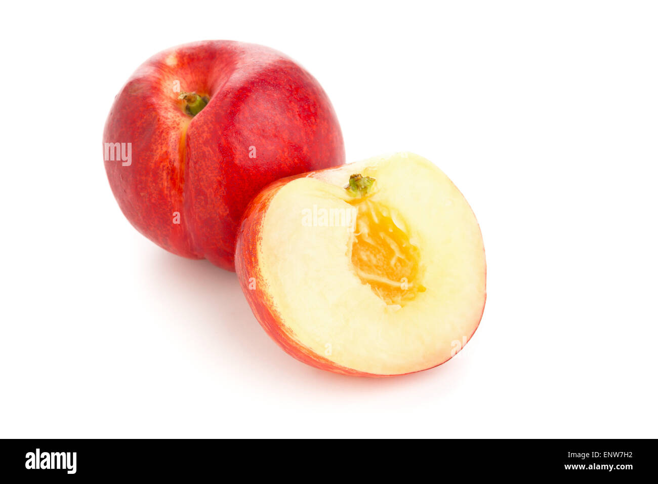 Whole and half cut white nectarine on white background Stock Photo Alamy