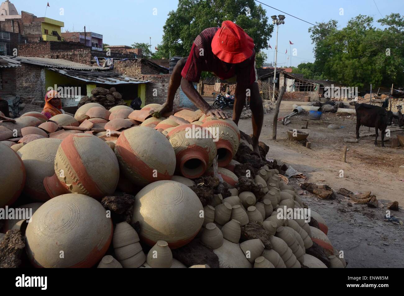 Allahabad, India. 11th May, 2015. A potter puts the earthen pitcher on