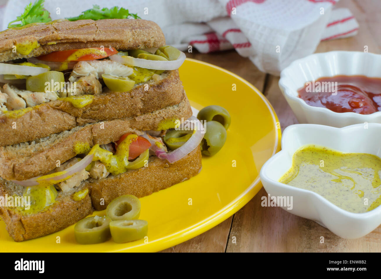 chicken and olive sandwich with mustard sauce and ketchup Stock Photo