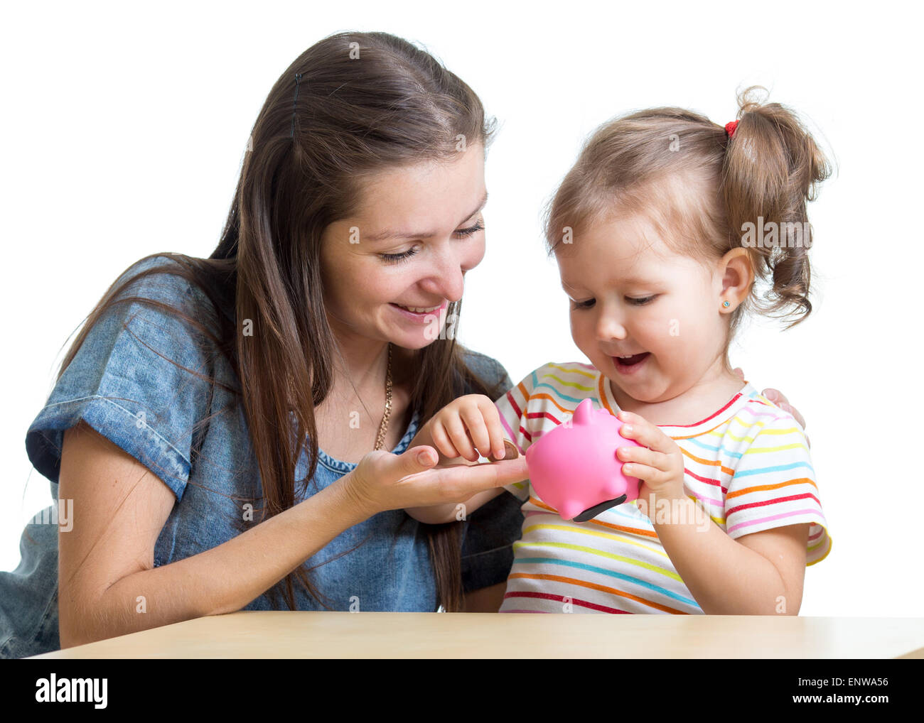 Mother and daughter put coins into piggy bank Stock Photo - Alamy