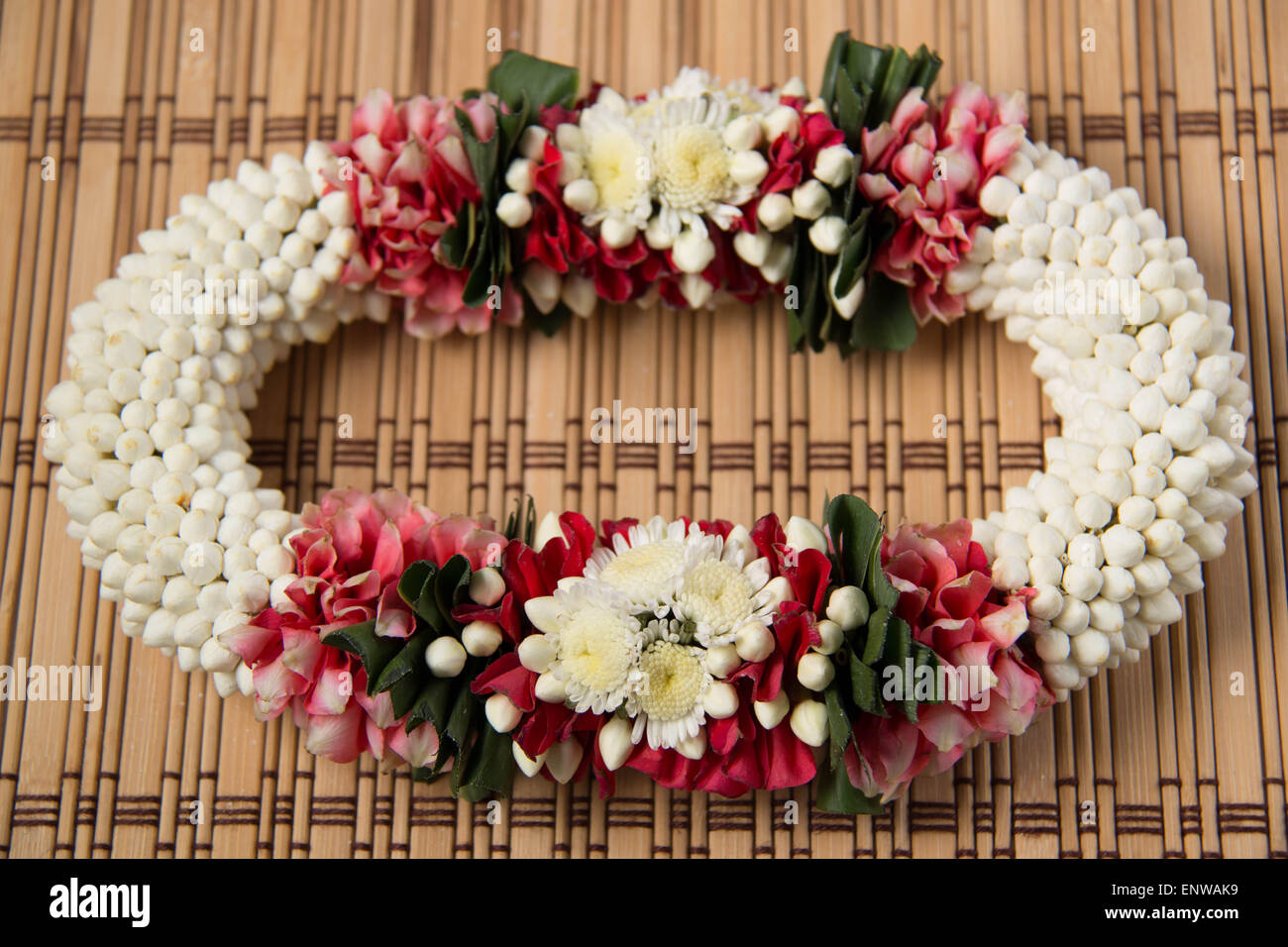 Thai traditional craft flower garland  on wood  background. Stock Photo