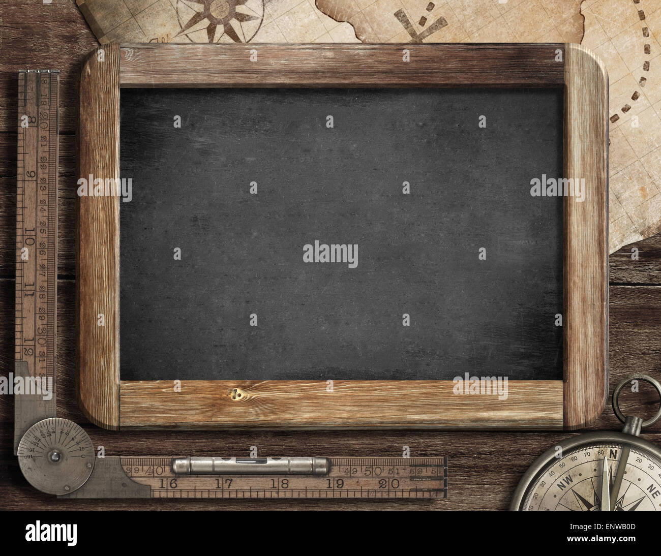 Vintage blackboard with treasure map, old compass and ruler. Adventure and discovery concept. Stock Photo