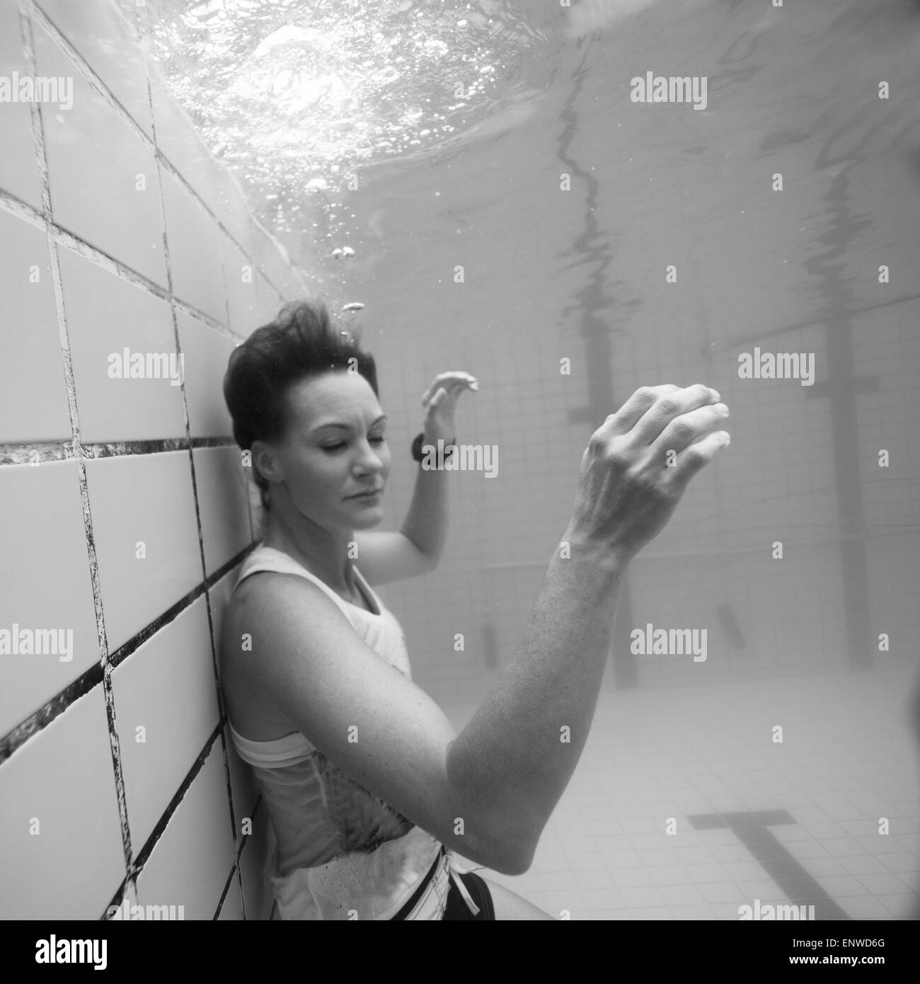 Woman freediving in a pool Stock Photo