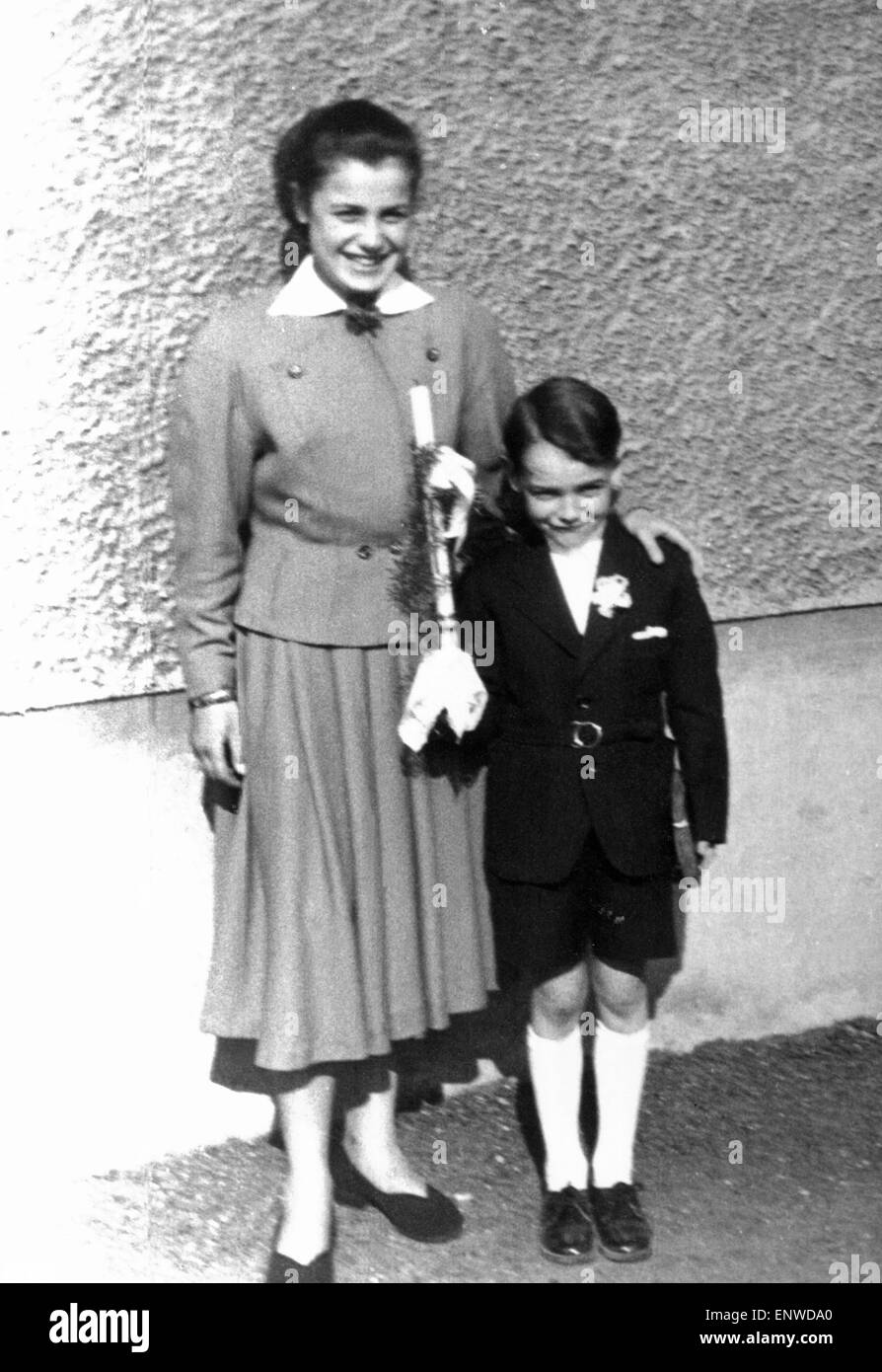 Fifties, religion, Christendom, First Communion, childrens communion, communion child with communion candle and prayerbook, boy, 8 to 10 years, posing with the sister in a pleated skirt, 16 to 18 years, Doris, Werner Stock Photo