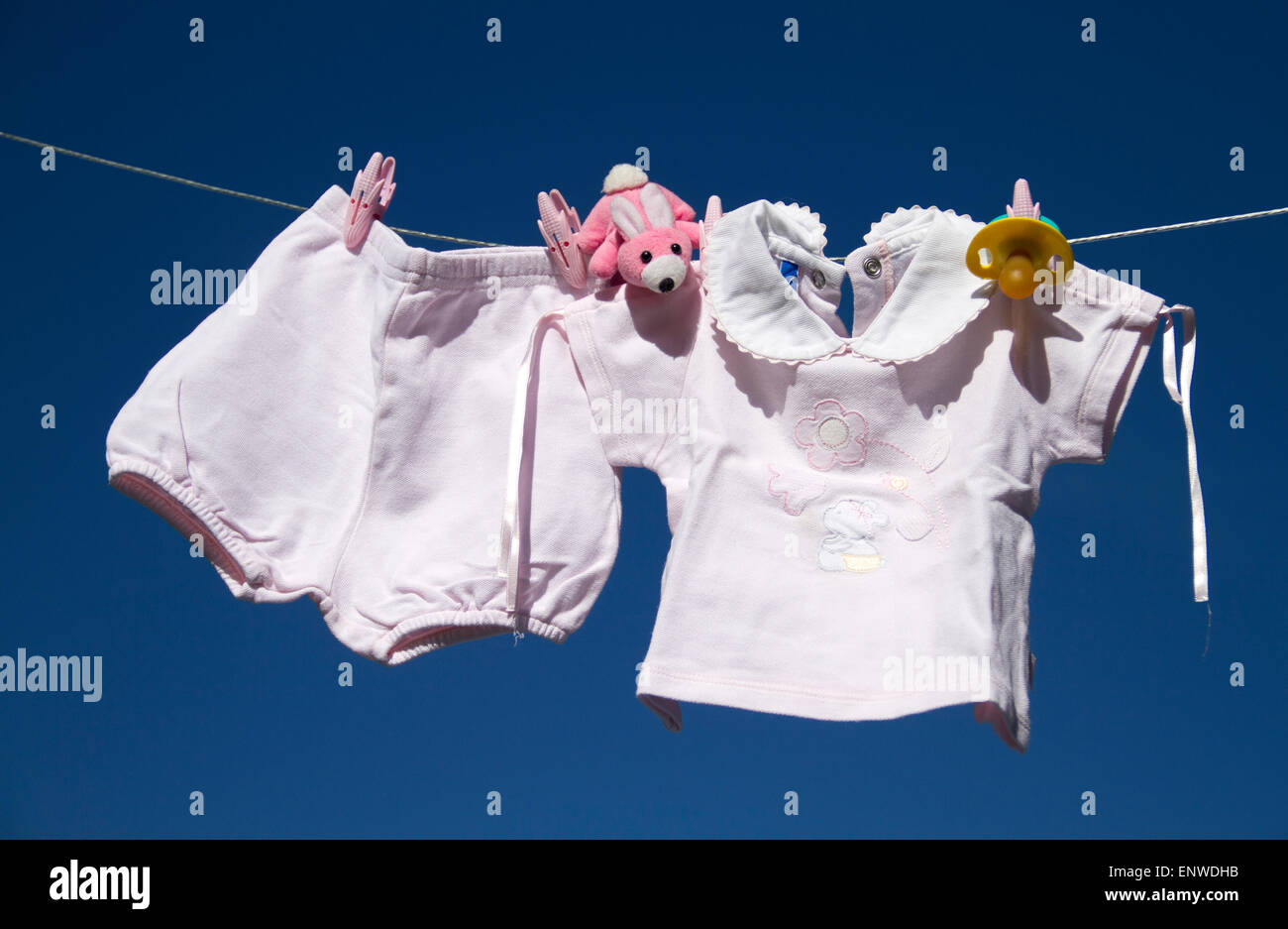 baby clothes in blue sky Stock Photo