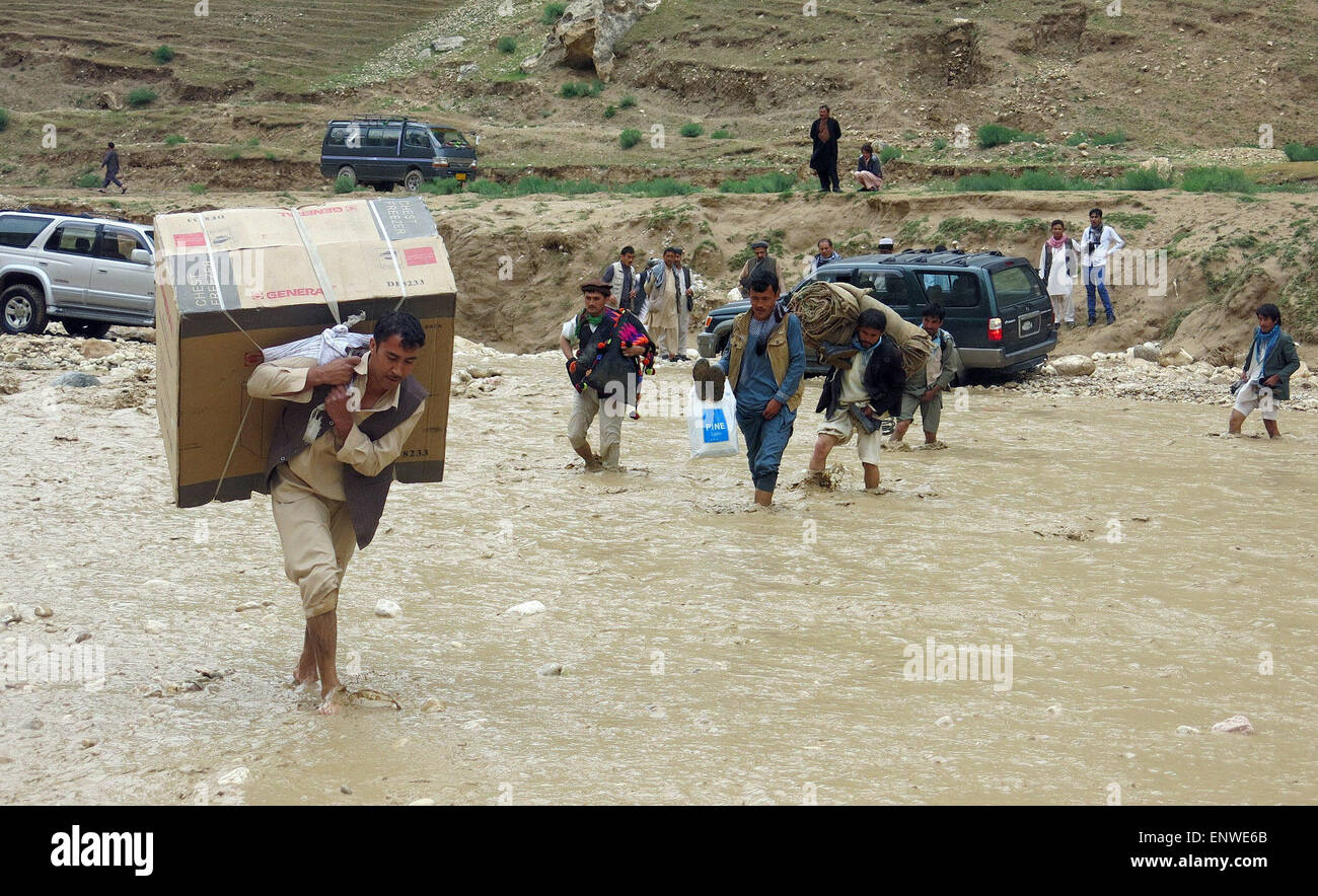Samangan, Afghanistan. 12th May, 2015. Afghans carry their goods from the flooded area after a heavy rain in Samanagan province, northern Afghanistan, May 12, 2015. Credit:  Azorda/Xinhua/Alamy Live News Stock Photo