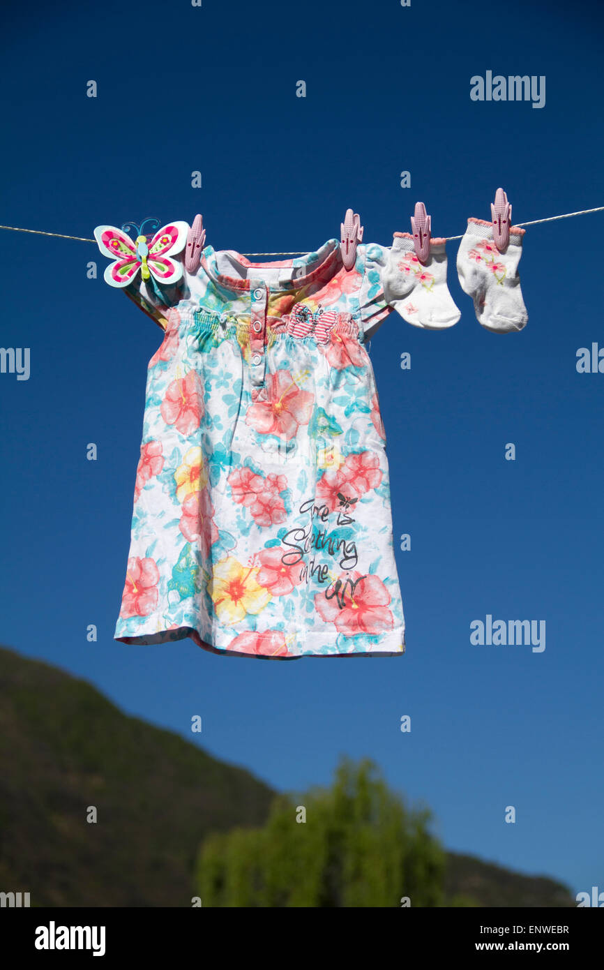 baby clothes in blue sky Stock Photo