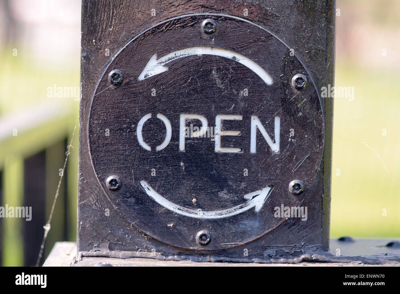 Open sign on canal lock gate with anti-clockwise direction arrow Stock Photo