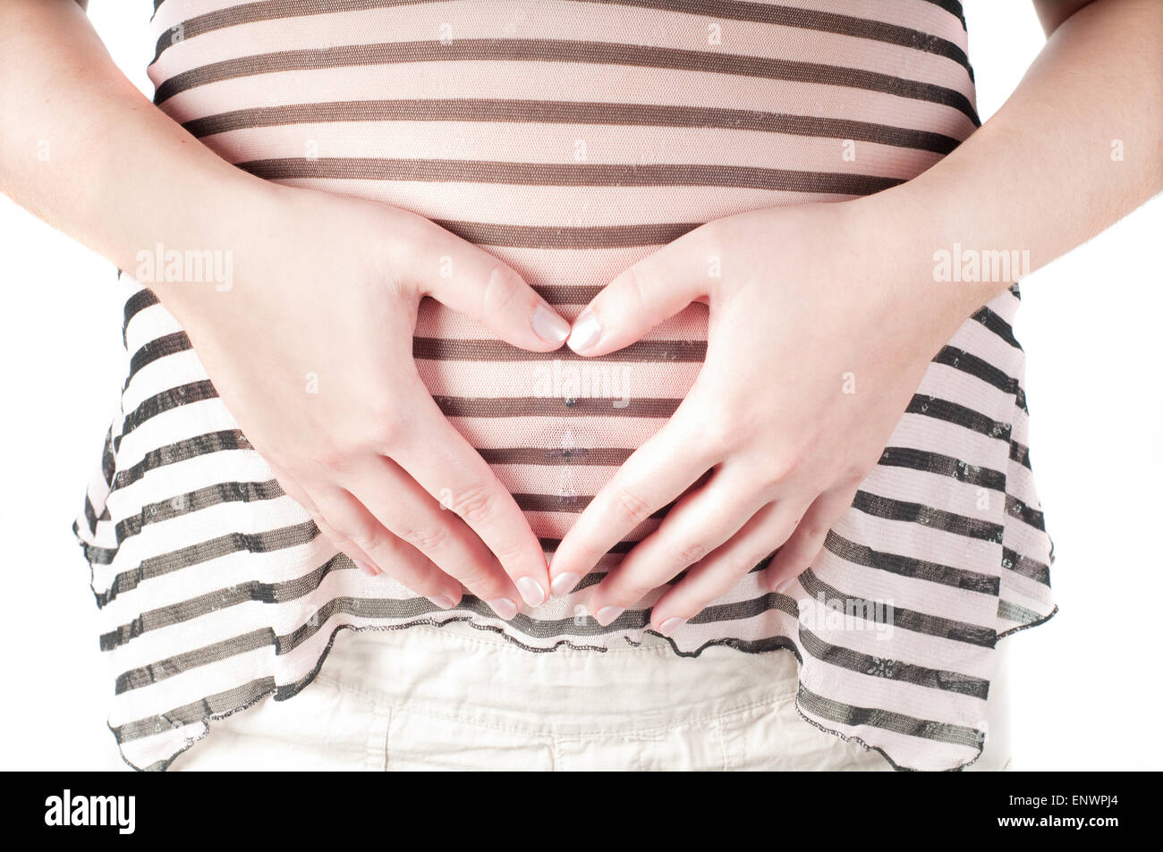 Pregnant woman hands in form of heart sign Stock Photo