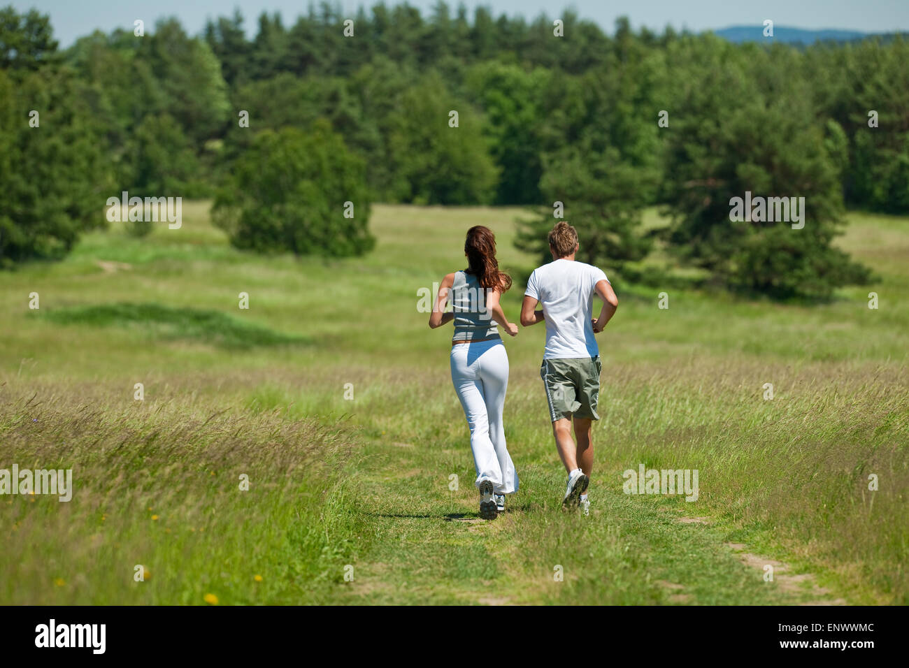 Young couple jogging outdoors in spring nature Stock Photo - Alamy