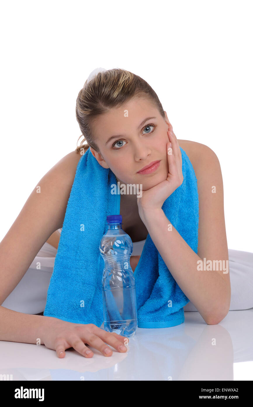 Fitness - Young sportive woman with water and towel Stock Photo - Alamy