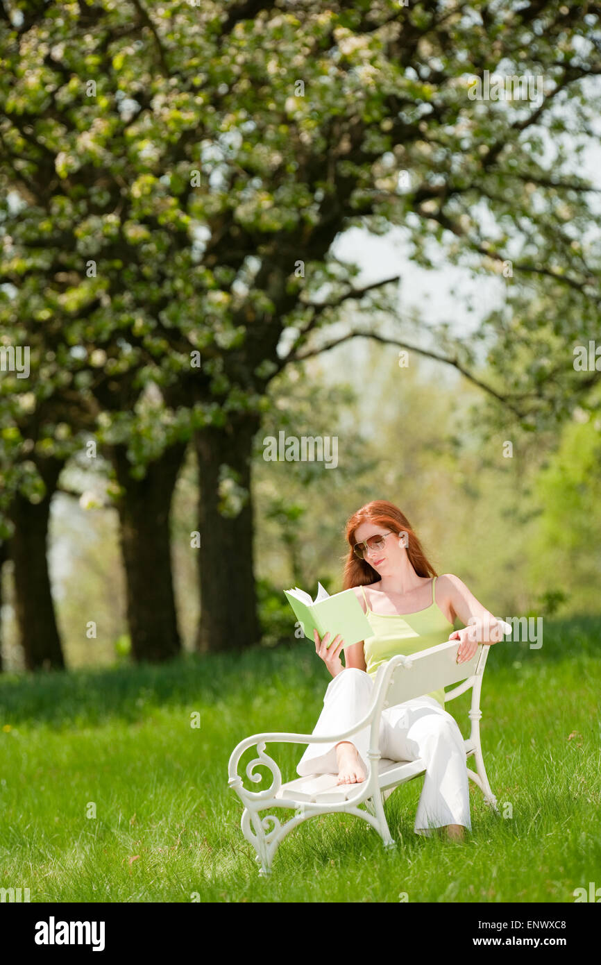 Young woman relaxing under blossom tree in spring Stock Photo - Alamy