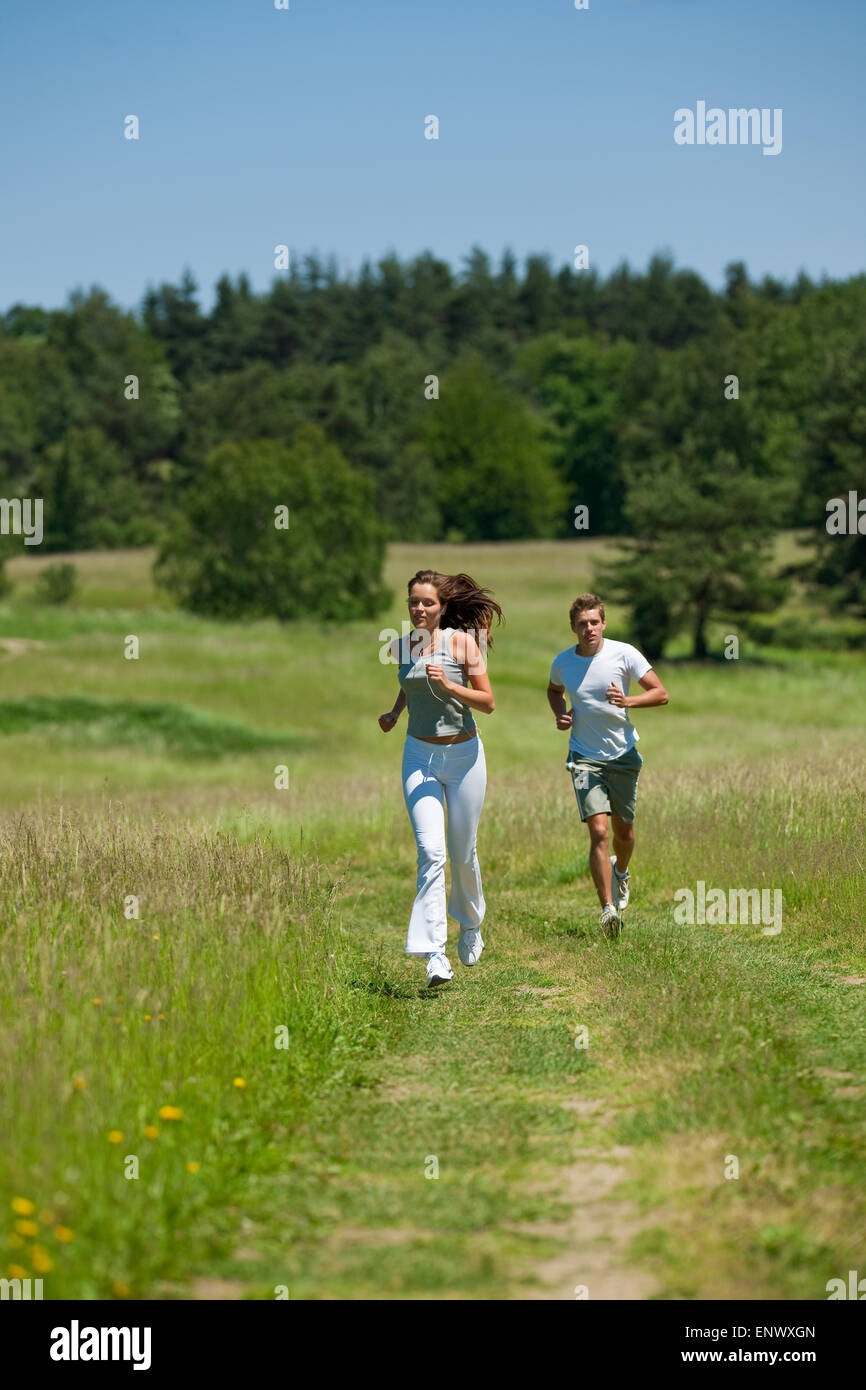 Young couple jogging outdoors in spring nature Stock Photo - Alamy
