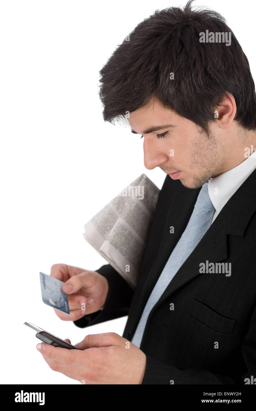 Young businessman holding mobile phone and credit card Stock Photo