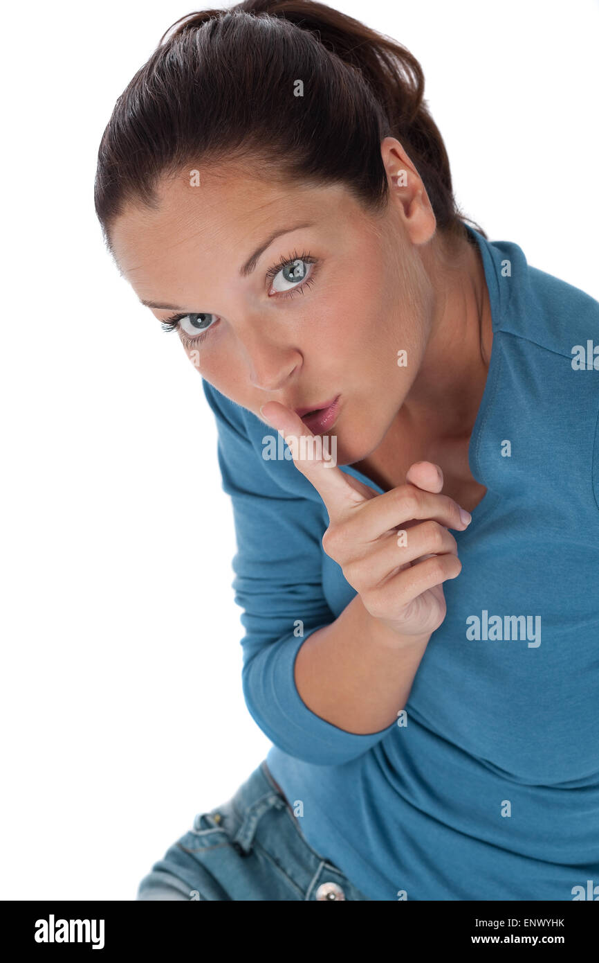 Young woman with finger on lips on white background Stock Photo - Alamy