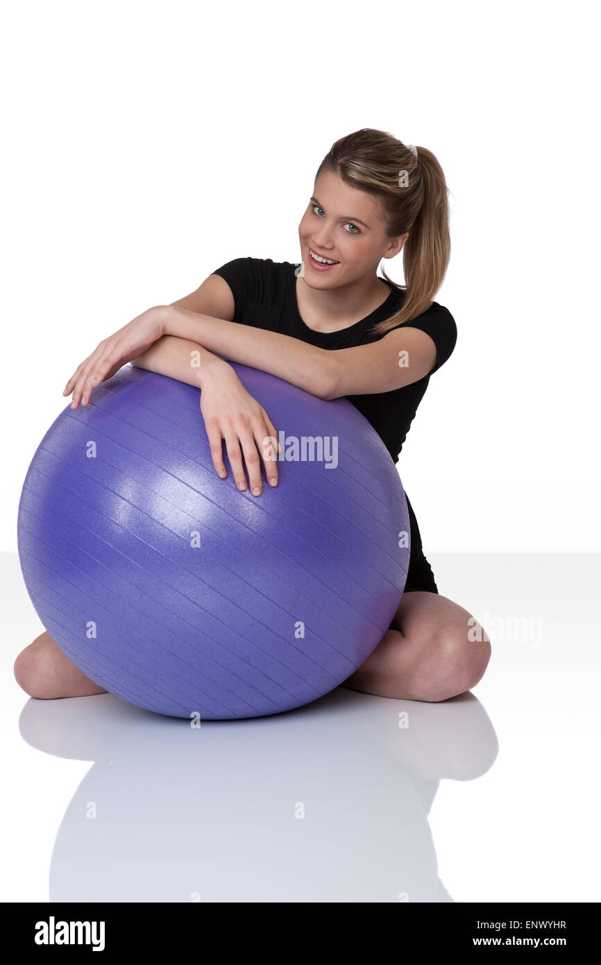 Fitness - Young woman with exercise ball on white Stock Photo - Alamy