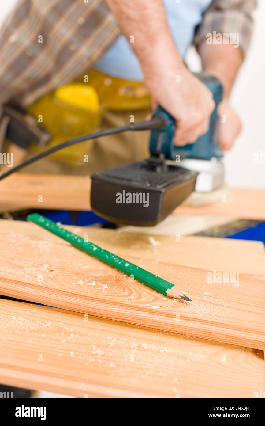 Handyman mature professional sanding wooden hi-res stock photography ...
