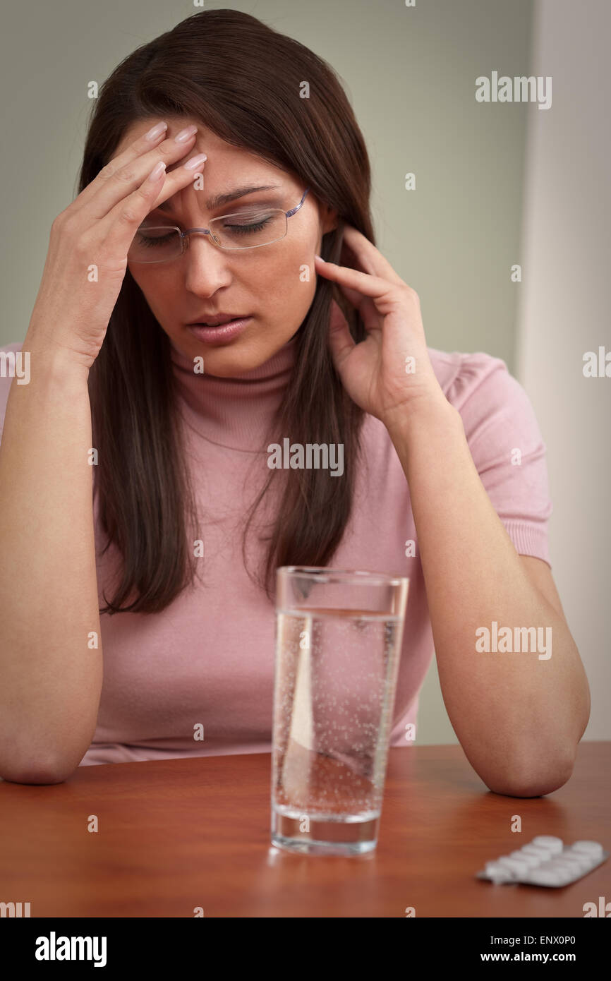 Businesswoman with headache take pill at office Stock Photo Alamy