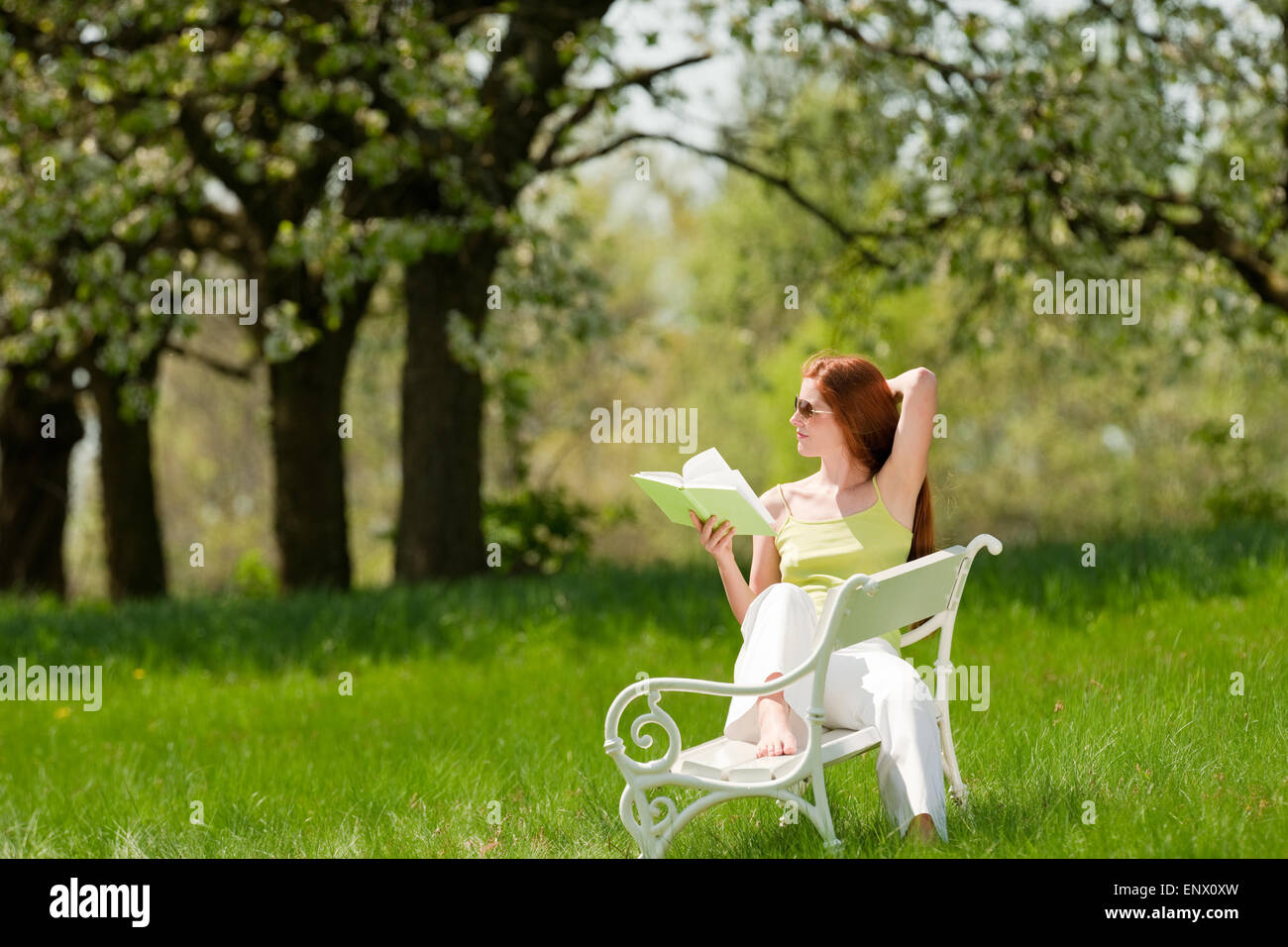 Young woman relaxing under blossom tree in spring Stock Photo - Alamy