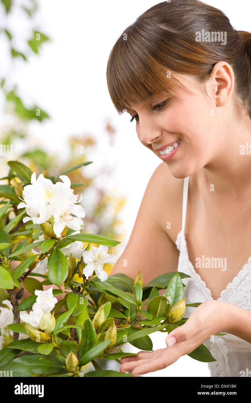 Gardening - Portrait of woman with Rhododendron flower Stock Photo