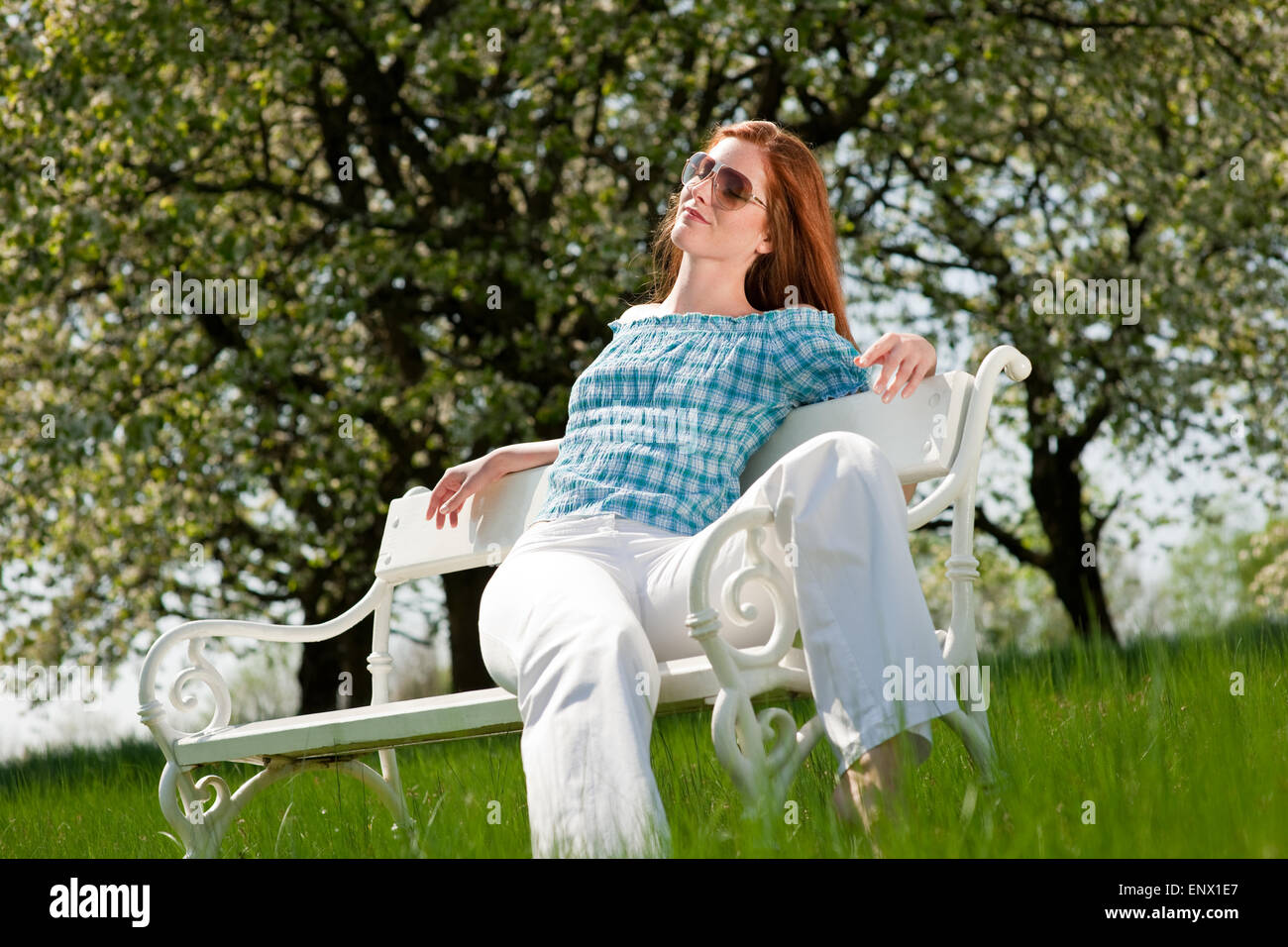 Young woman relaxing under blossom tree in spring Stock Photo - Alamy