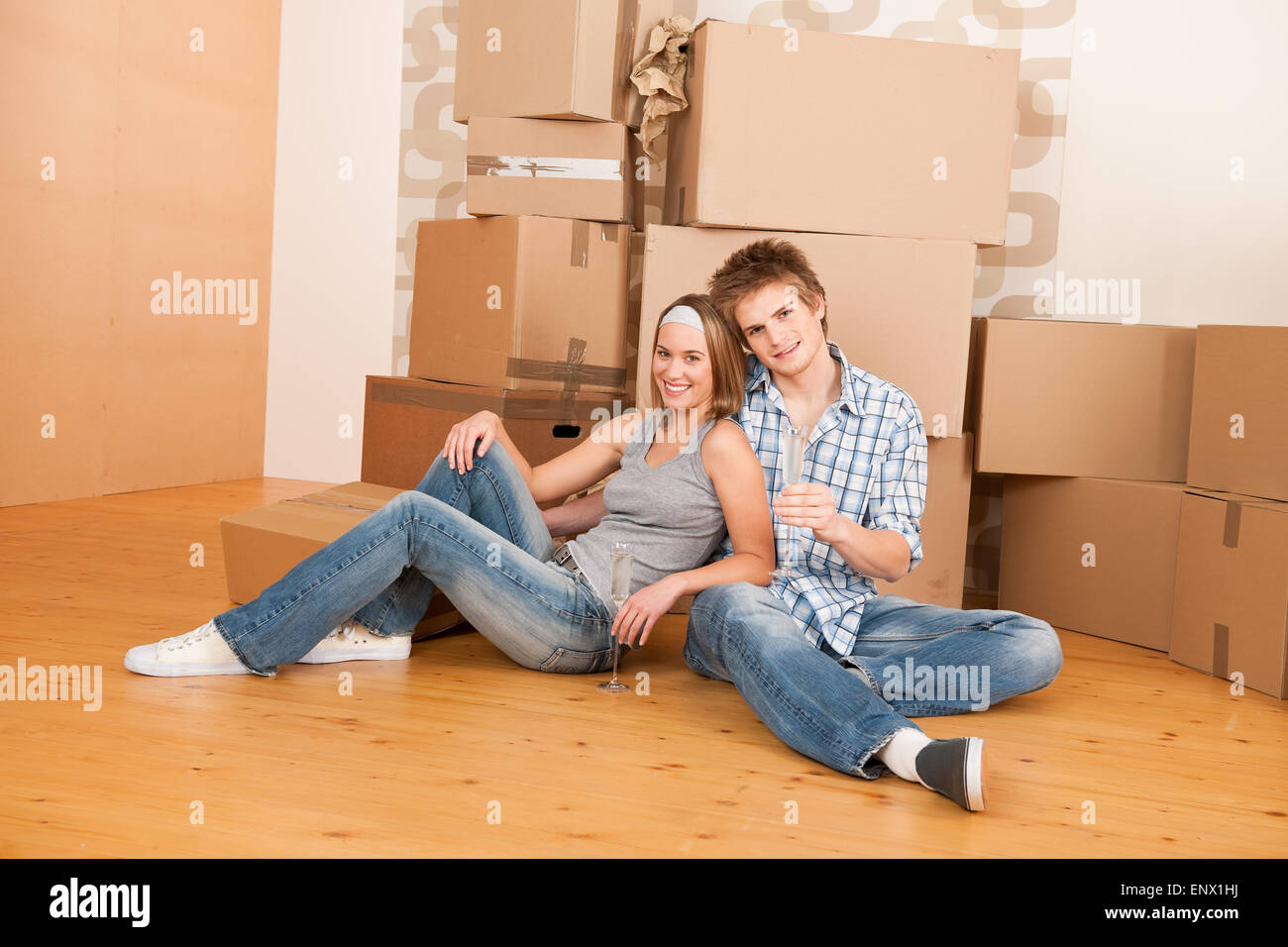 Moving house: Happy man and woman celebrating Stock Photo - Alamy