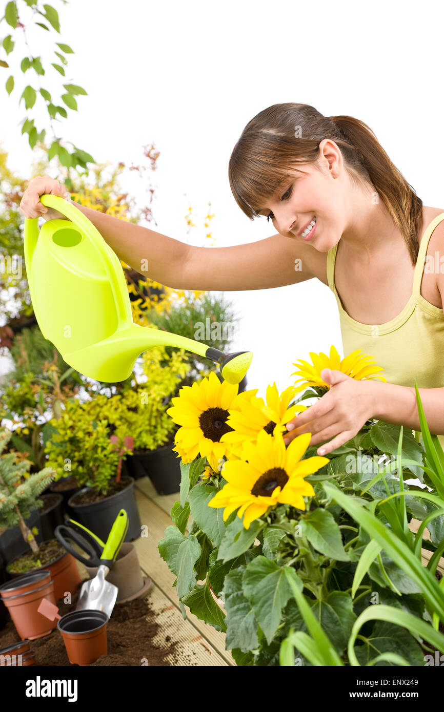 Gardening - woman with watering can and flowers pouring water Stock Photo