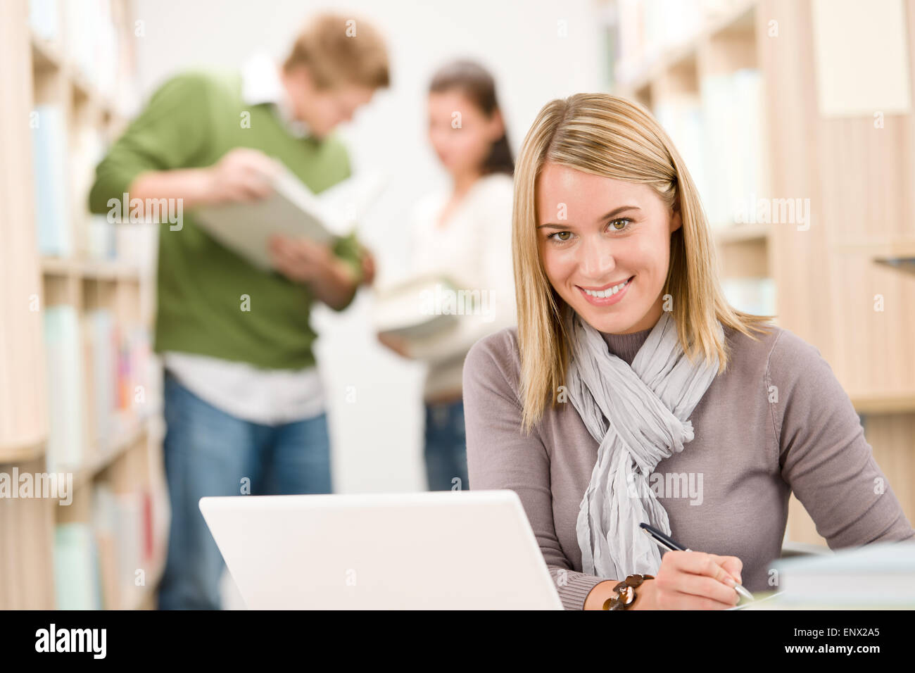 High school library - happy student with laptop Stock Photo - Alamy
