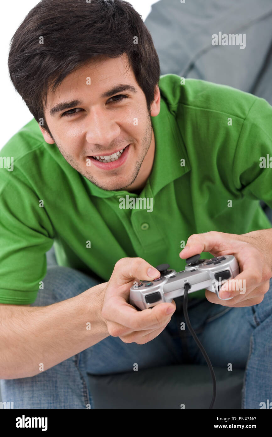 Young happy man playing video game with control pad Stock Photo