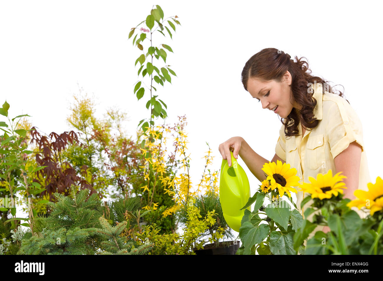 Gardening - Woman pouring plants with watering can Stock Photo