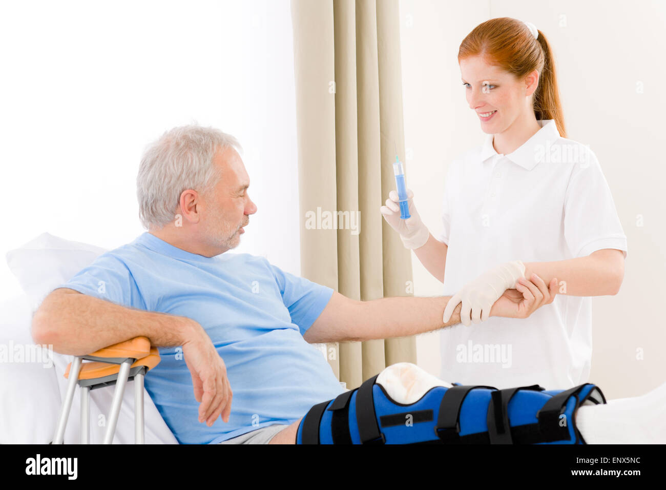 Hospital female nurse syringe patient broken leg Stock Photo Alamy