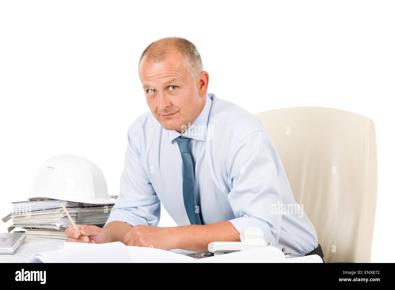 Professional architect with blueprint behind table Stock Photo - Alamy