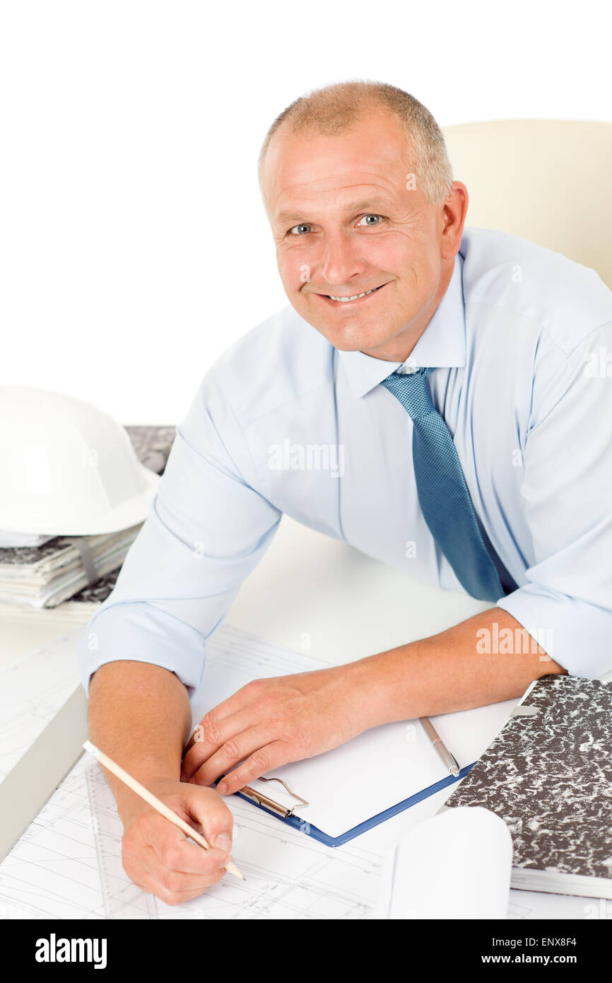 Professional architect with blueprint behind table Stock Photo - Alamy