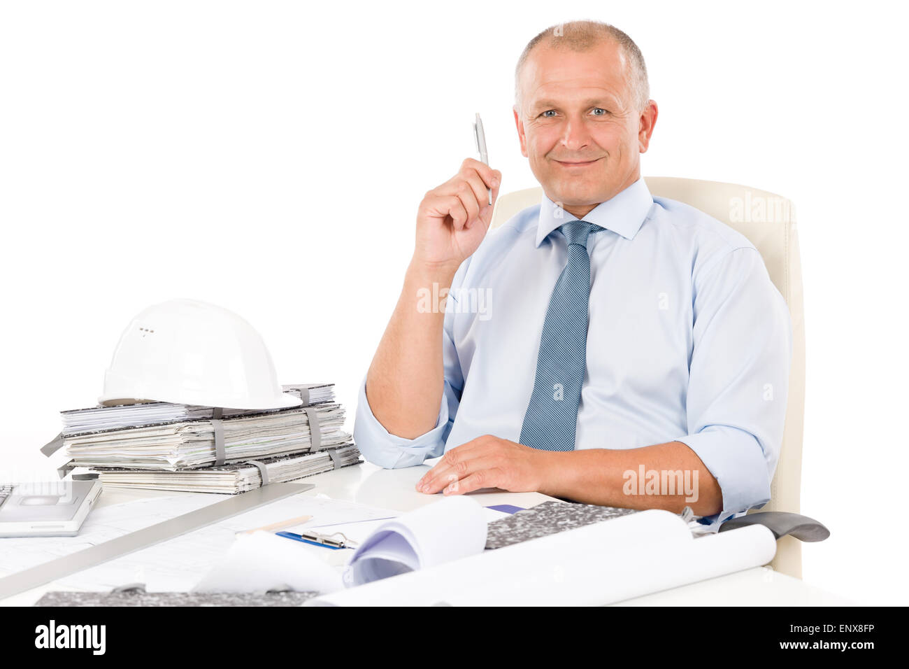 Professional architect with blueprint behind table Stock Photo - Alamy