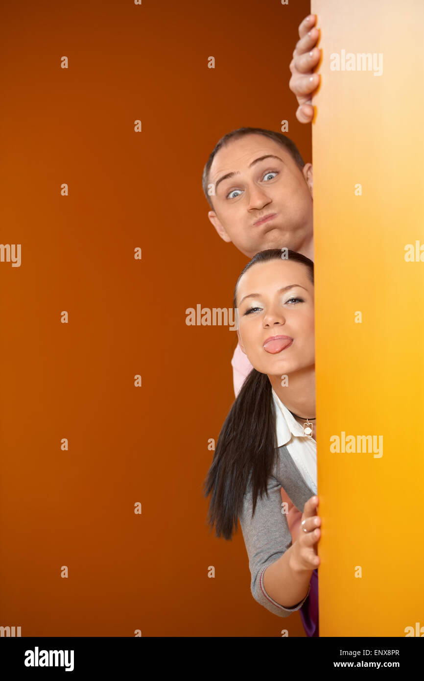 The young pair looks out because of an orange corner and grimaces Stock Photo