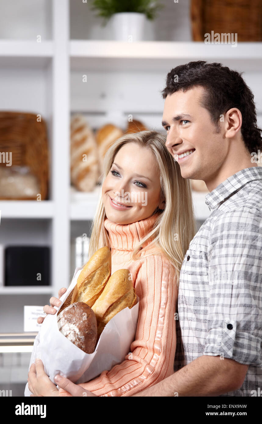Beautiful couple with grain products on a forward background Stock Photo