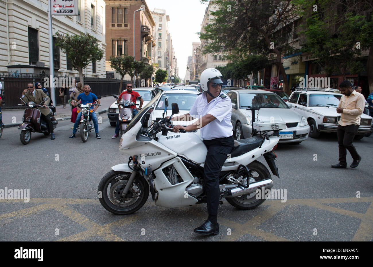 A police officer on a motorcylce blocks a street in downtown Cairo, Egypt, 04 May 2015. BERND VON JUTRCZENKA/dpa Stock Photo