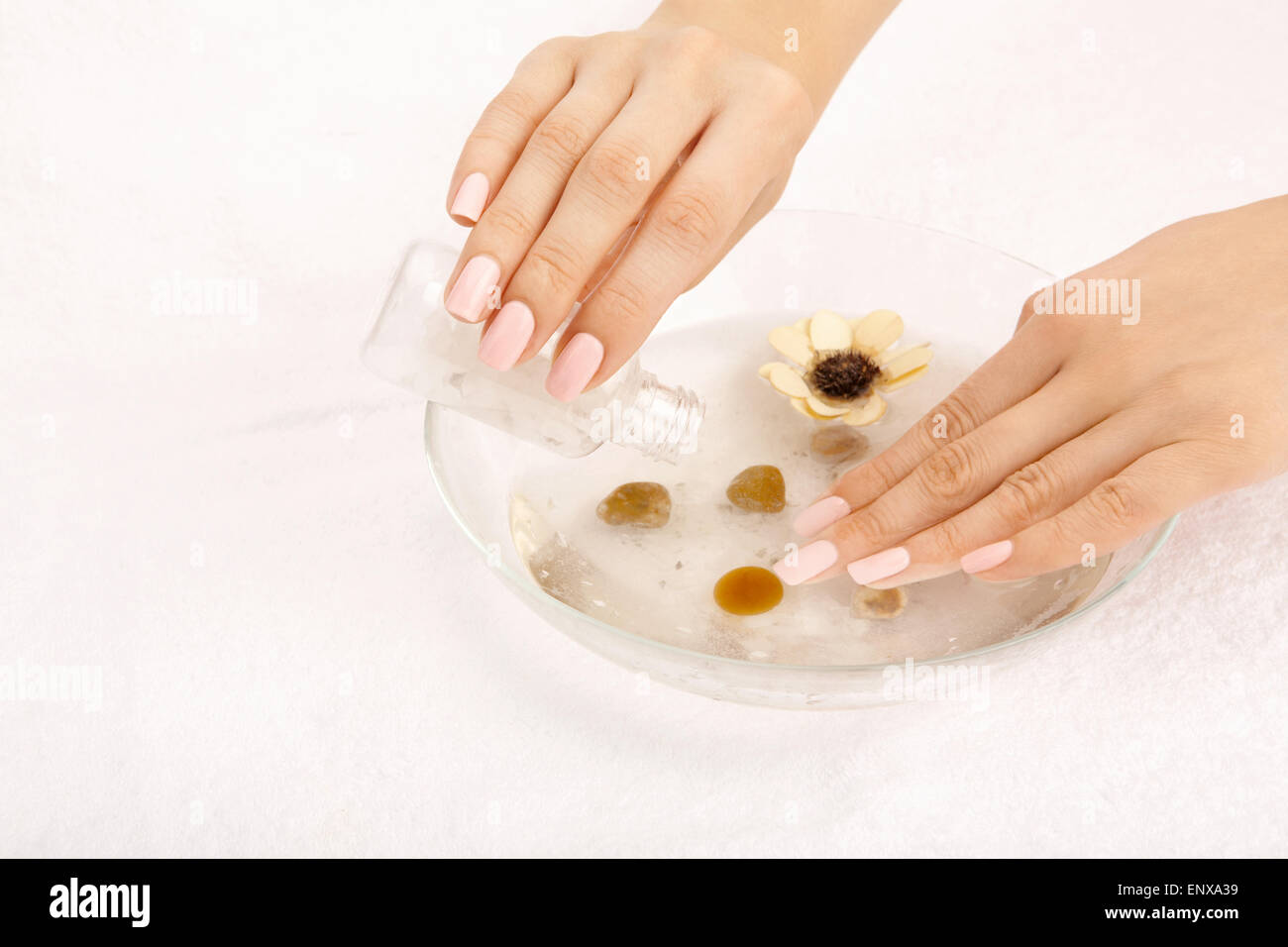 Female hands fill salt in capacity with a cosmetic solution Stock Photo