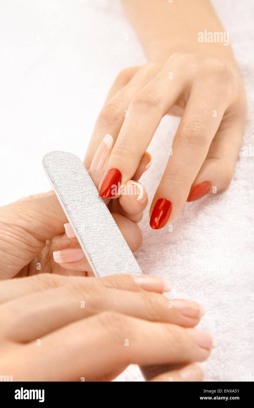 Professional processing of nails by a nail file Stock Photo