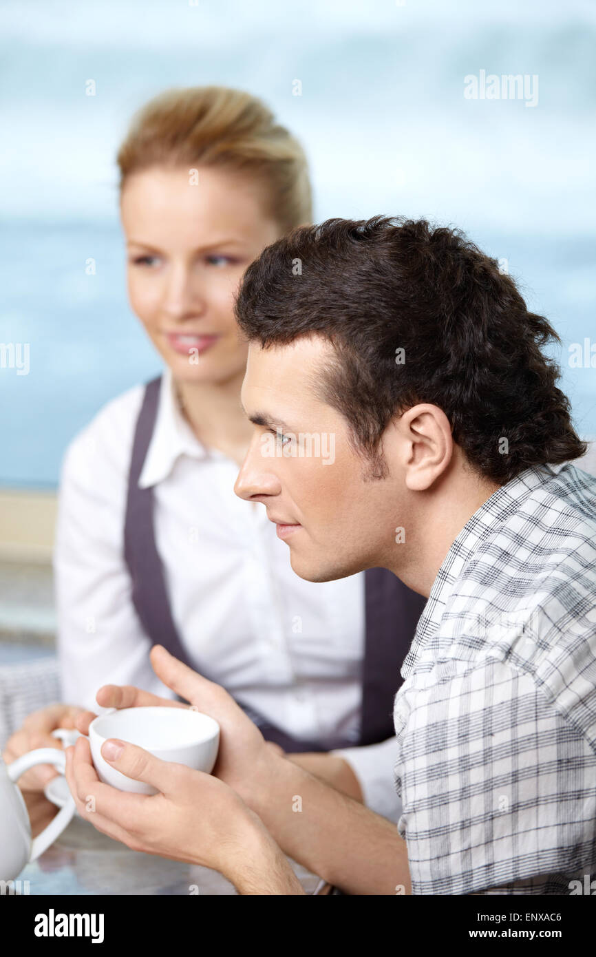 The attractive man and the girl drink coffee Stock Photo