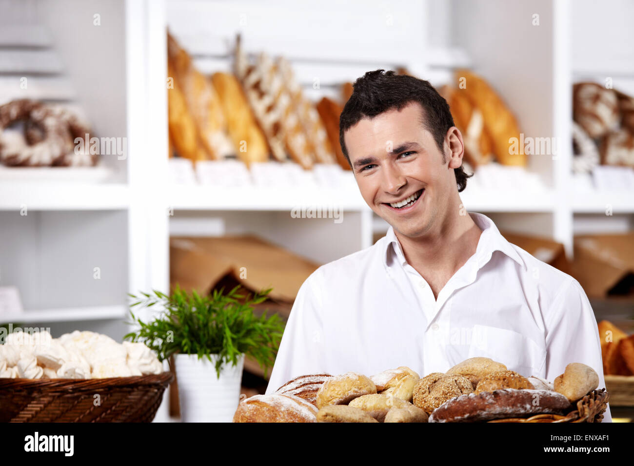 The young seller with a basket of rolls close up Stock Photo