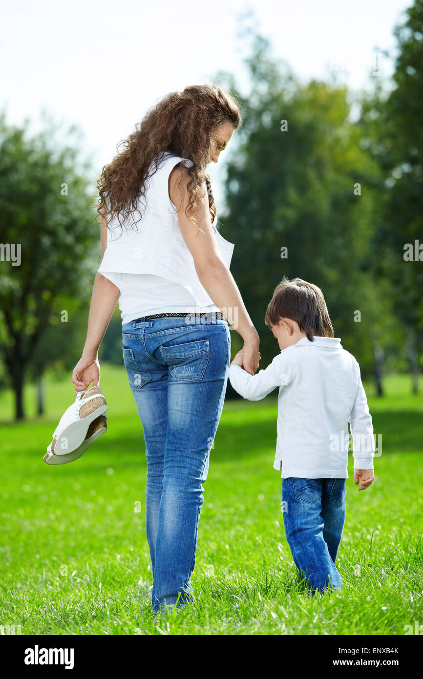 https://c8.alamy.com/comp/ENXB4K/mother-with-the-small-son-barefoot-walk-on-a-summer-grass-in-park-ENXB4K.jpg