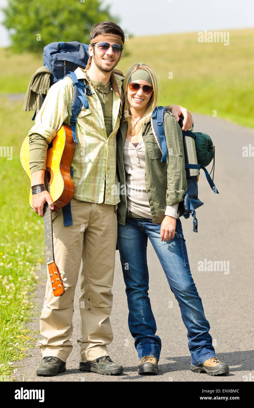 Hiking young couple backpack tramping asphalt road Stock Photo Alamy