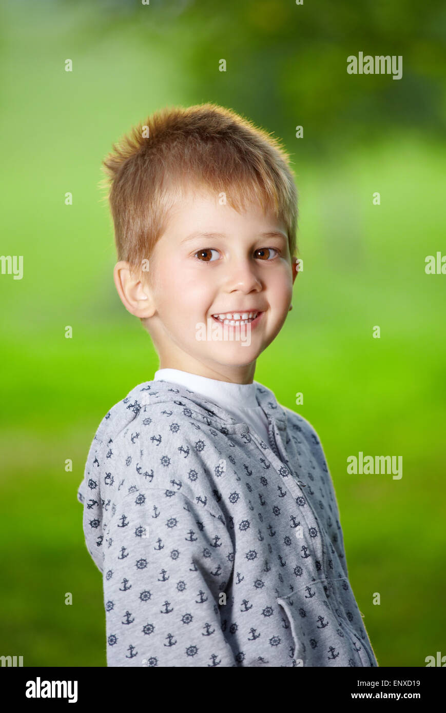 Smiling boy of preschool age against a summer garden Stock Photo
