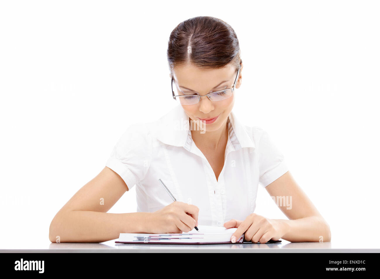 Beautiful business woman writes something in a weekly journal at table Stock Photo