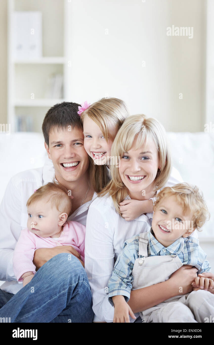 Attractive family with three children at home Stock Photo Alamy