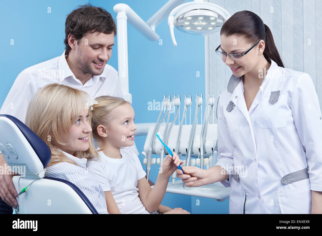 Dentist gives the child a toothbrush in the dental office Stock Photo
