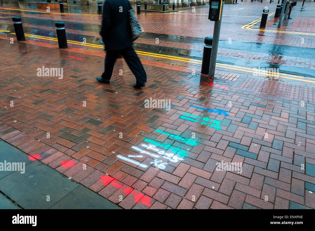 Spray painted markings on street for construction road works cable