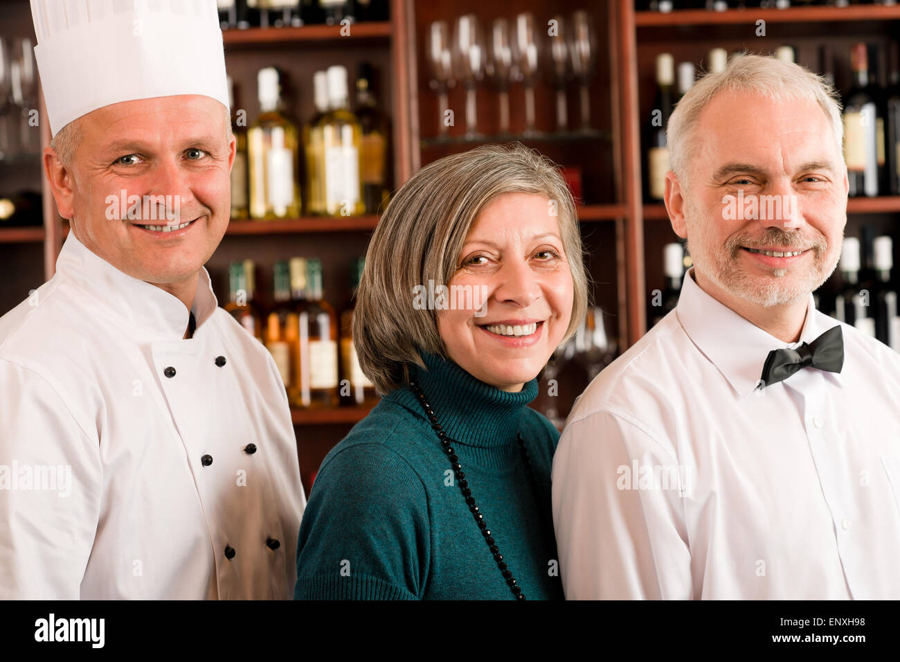 Restaurant manager posing with professional staff Stock Photo