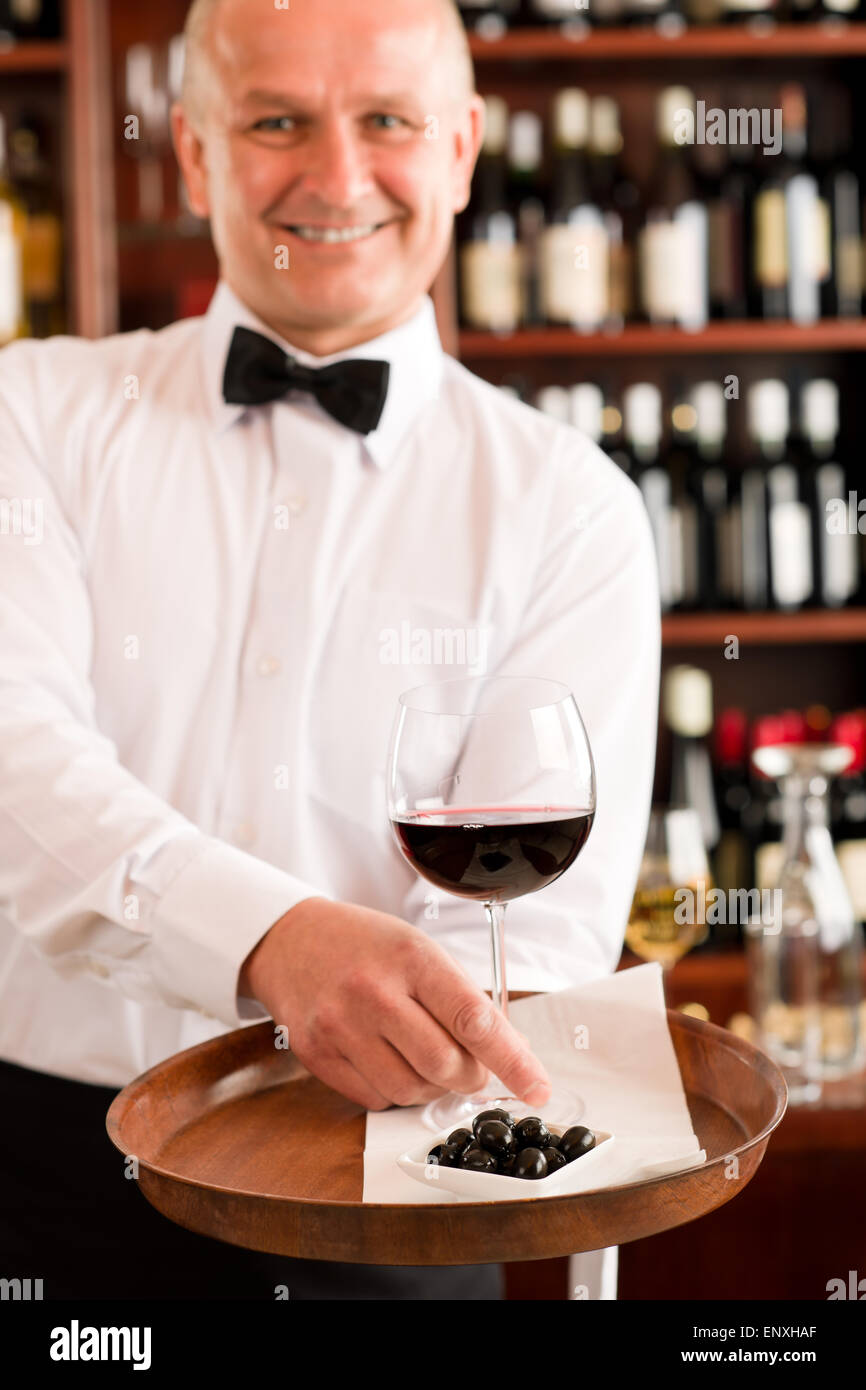 Wine bar waiter mature serve glass restaurant Stock Photo